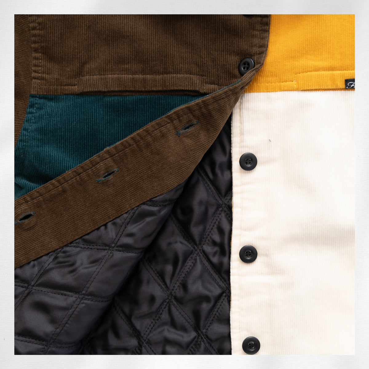 The 365 Jacket open front showing the dark quilted lining and snap fasteners