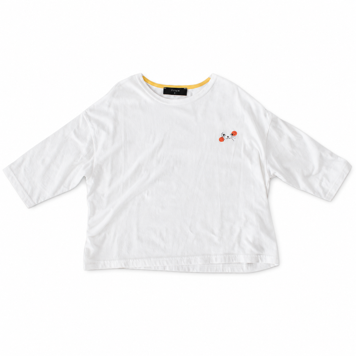 White Cat Nap Tee with relaxed sleeves, yellow inner neckline and a small black cat face with orange accents.