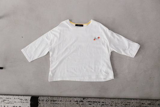 The white Cat Nap Tee is shown flat with a small cat-face graphic and orange accents on the chest.
