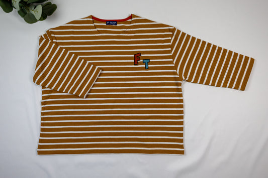 The Modern Sailor Tee is shown flat with brown-and-white stripes and red F and teal T chest lettering.