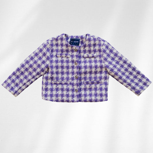 The Uptown Girl Jacket is shown flat with purple-and-cream checks, four round front buttons and flap details.
