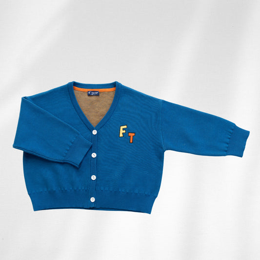 The blue Watch Me Grow Cardi is shown flat with a V-neck, four white buttons and yellow F and orange T chest lettering.