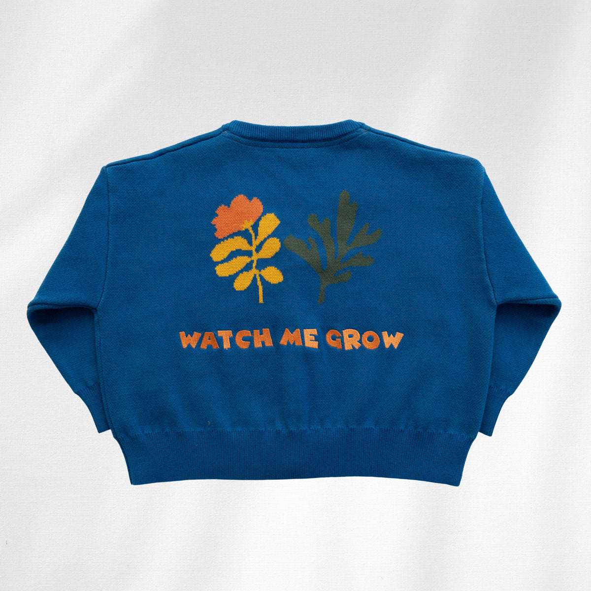 Watch Me Grow Cardi back with orange lettering and floral embroidery